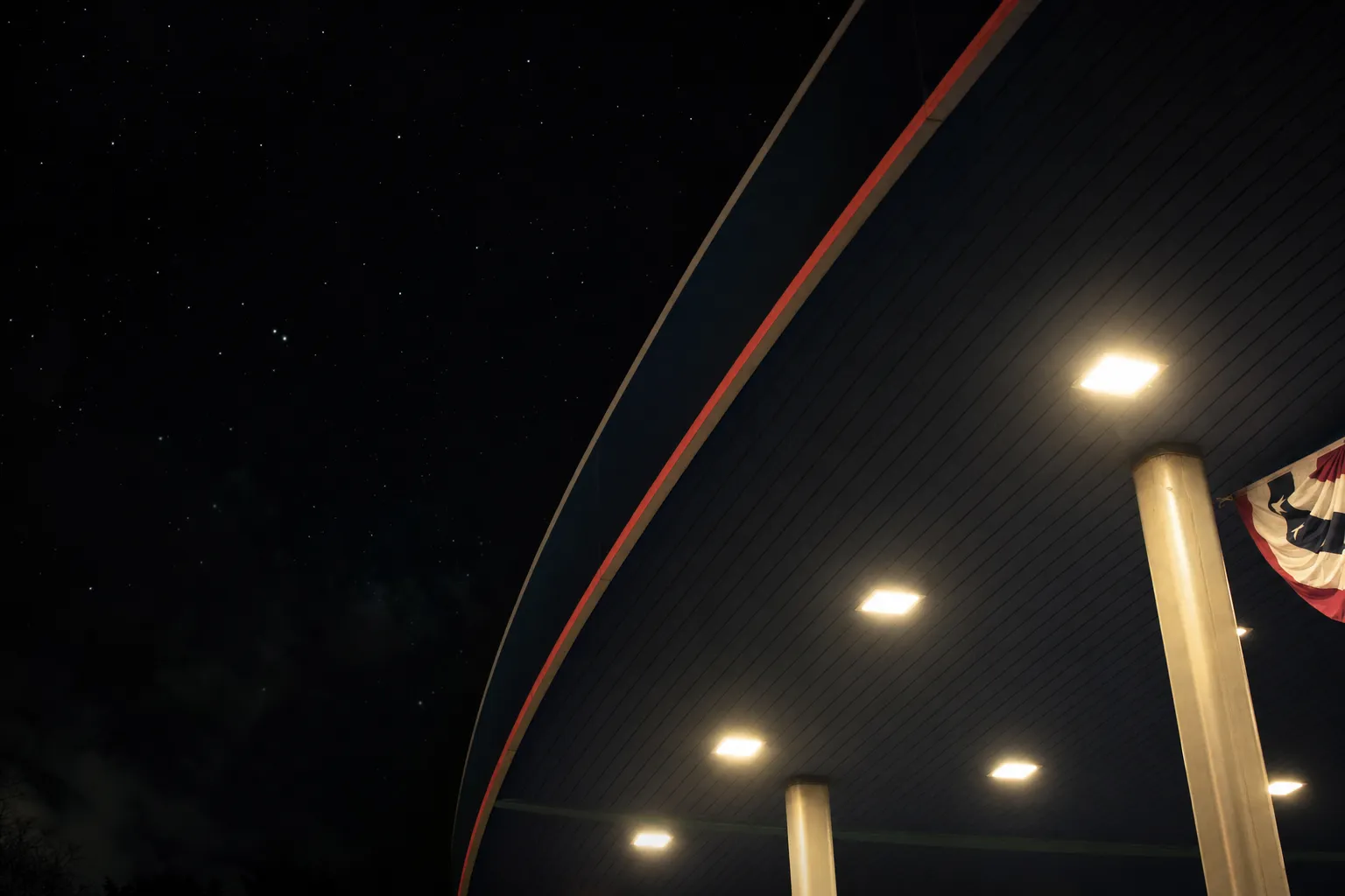 Petro USA fuel canopy lit up at night under a starry sky